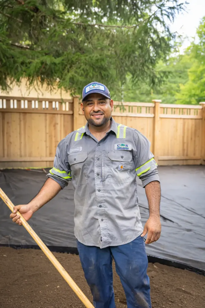 A C&S crew member smiling on a patio build