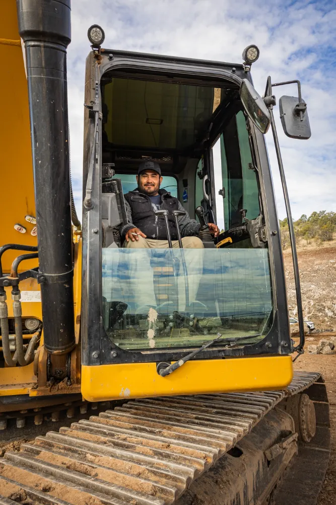 A CLM Earthmovers operator in the cab of his excavator